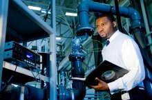 Engineer holding a folder performing a hardware checkup.