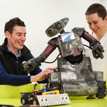 Tutor and student working with robots